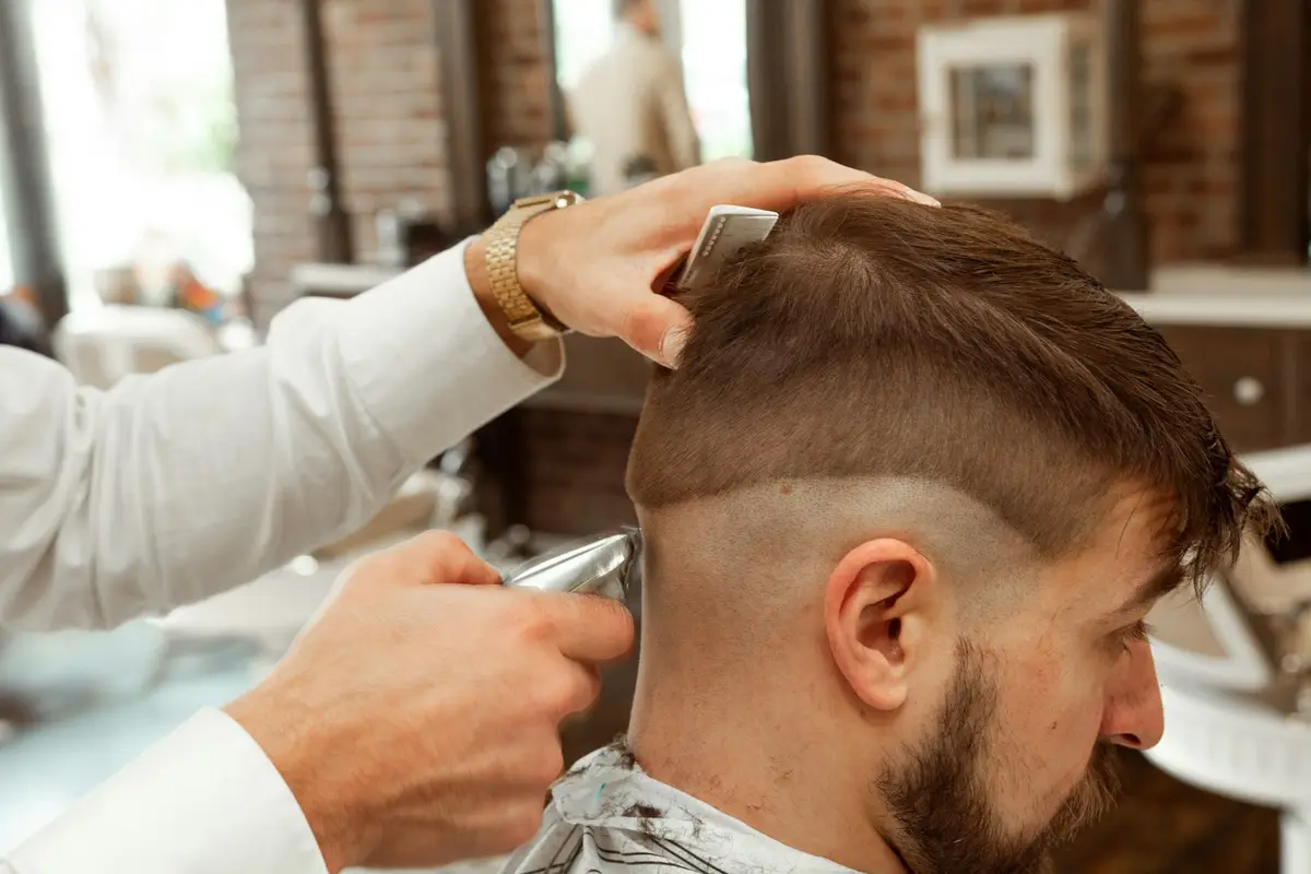Barber shaping a fade