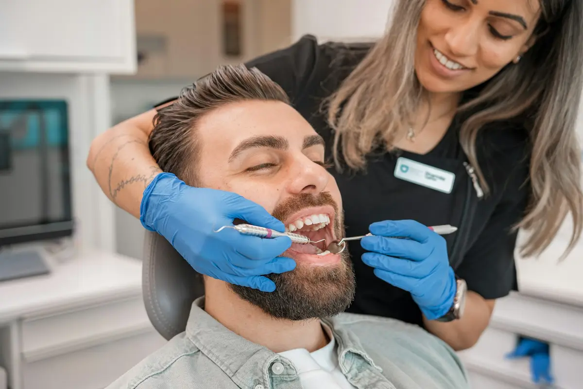 Dentist examining a smiling patient