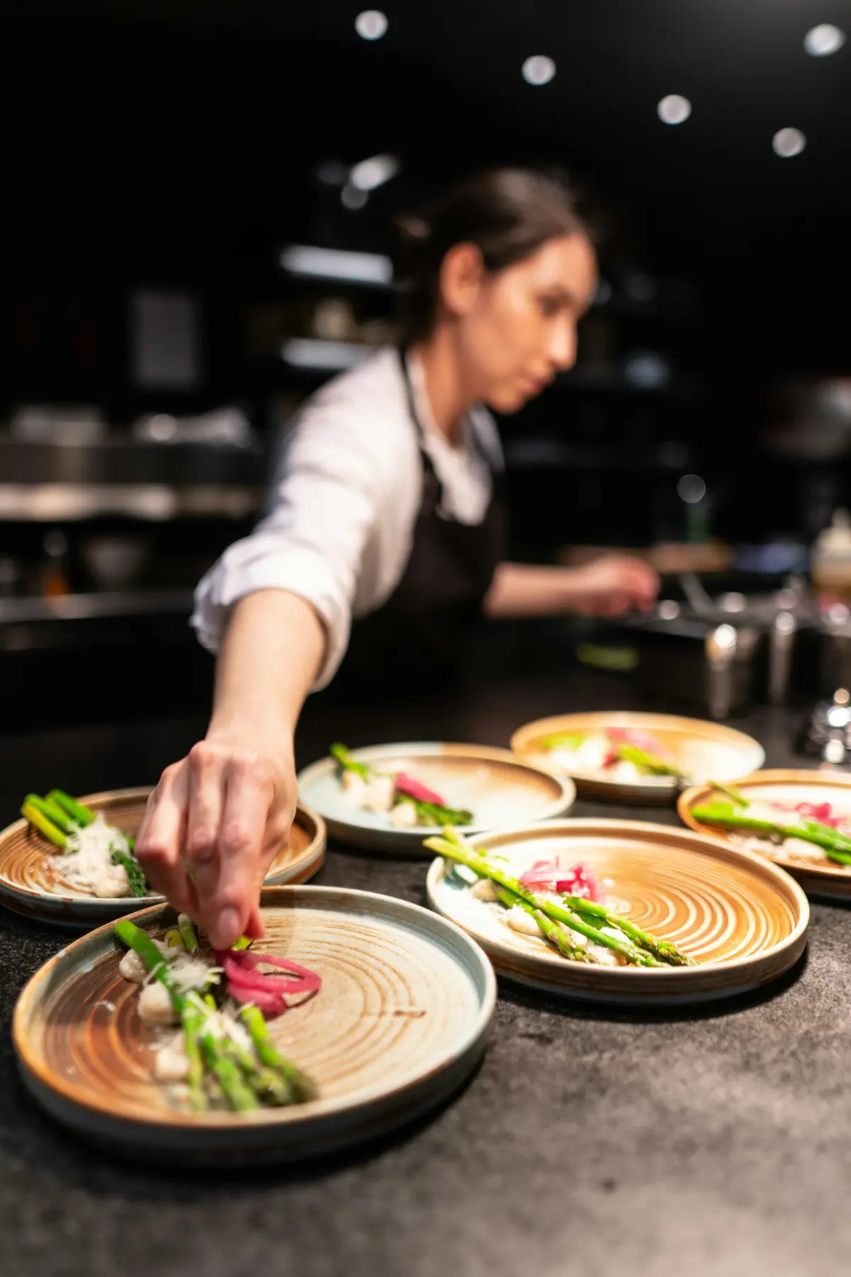 Dishes being finished at the pass